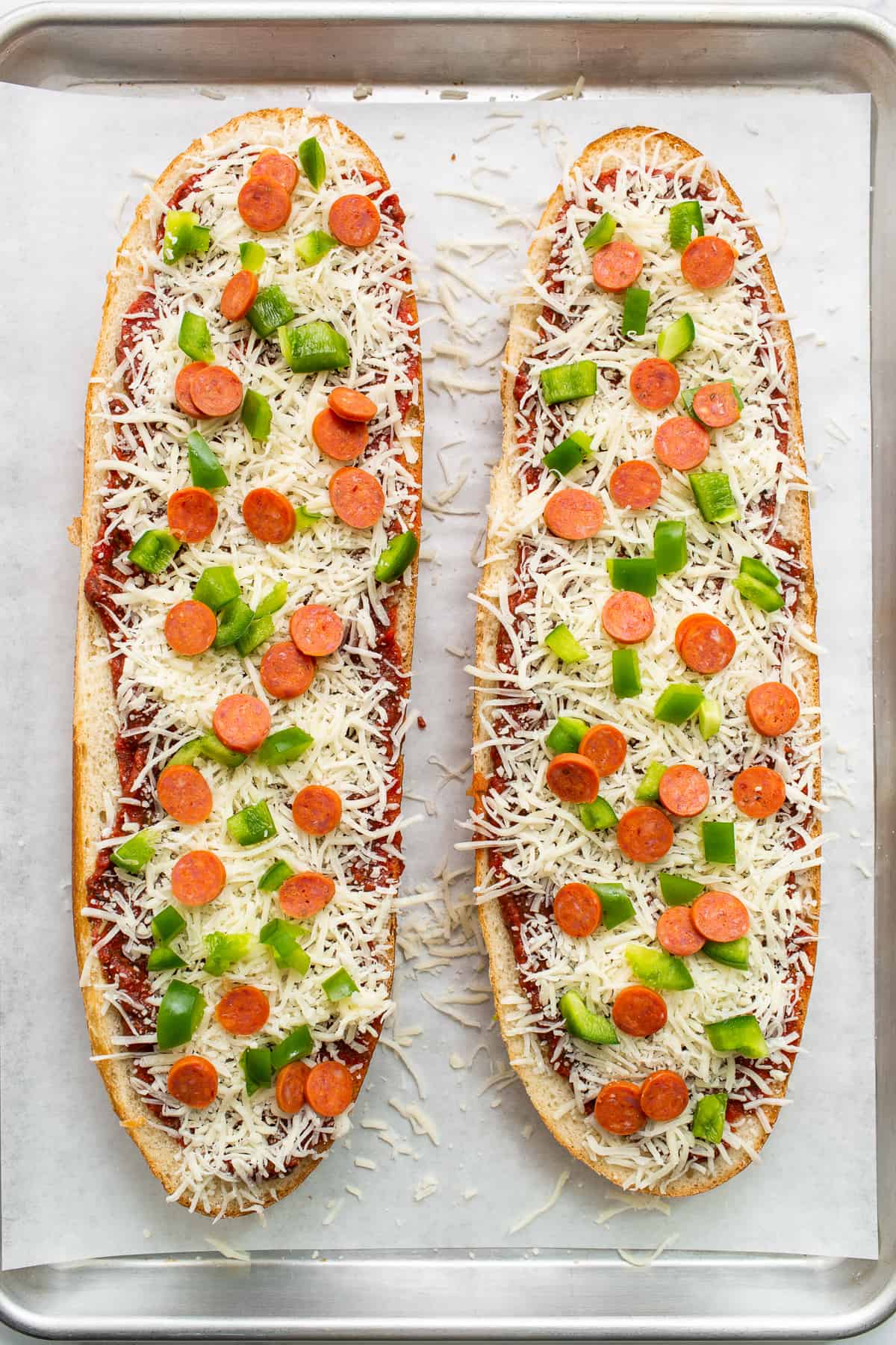 French bread pizza on a baking sheet.