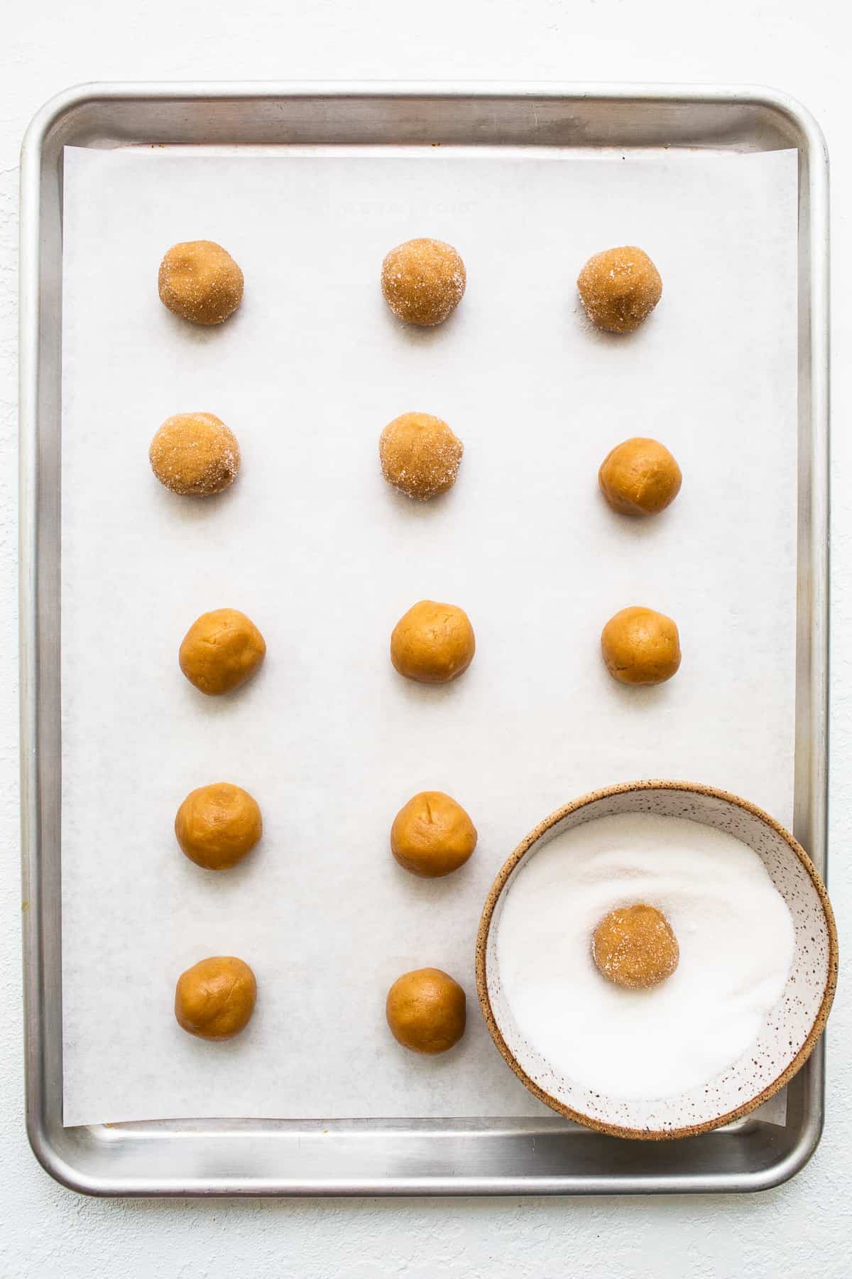 Peanut butter kiss cookies on a baking sheet.