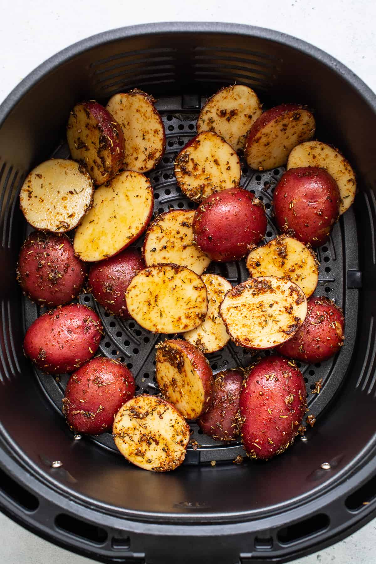 Sliced potatoes in the air fryer.