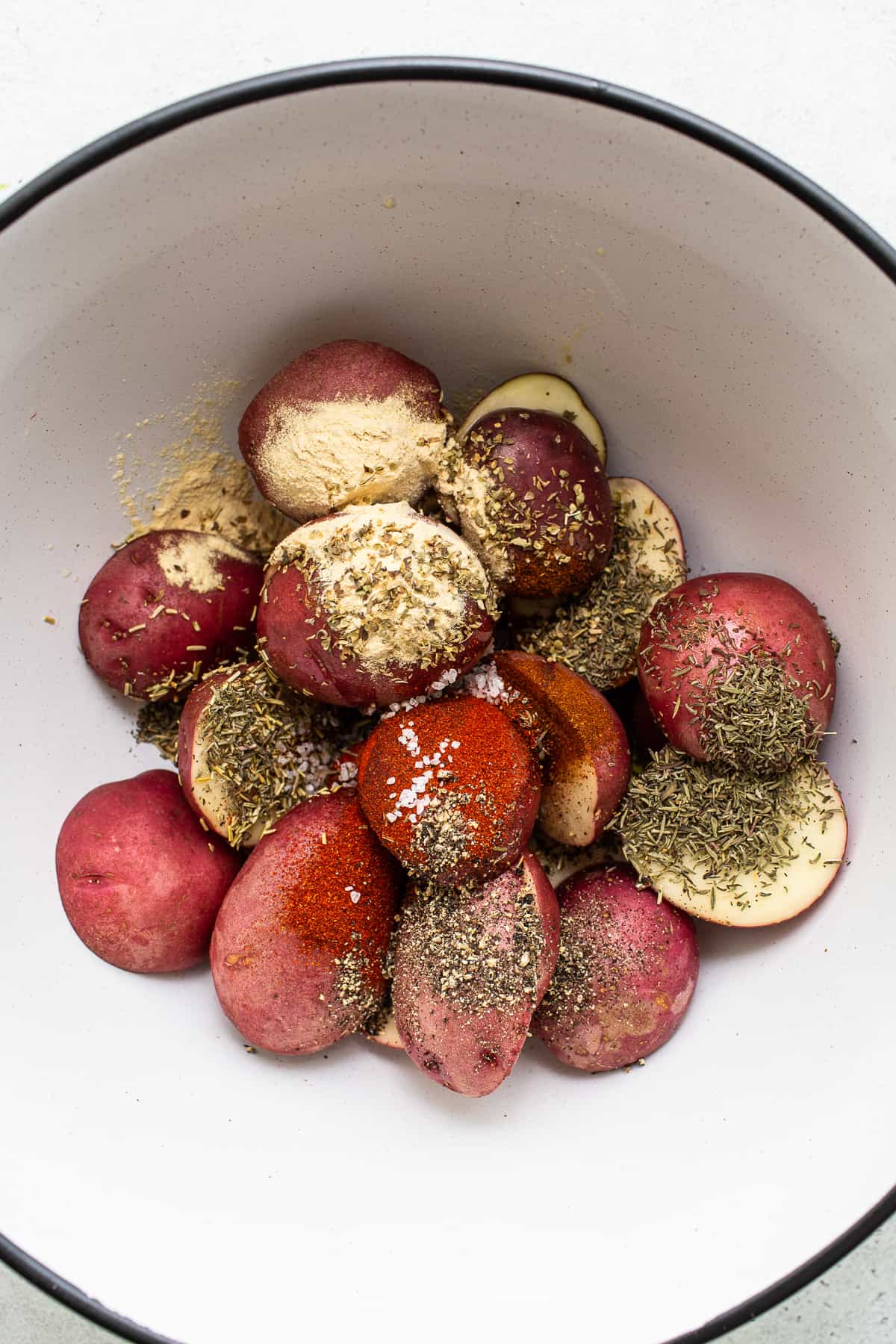 Air fryer potatoes in a bowl with spices.