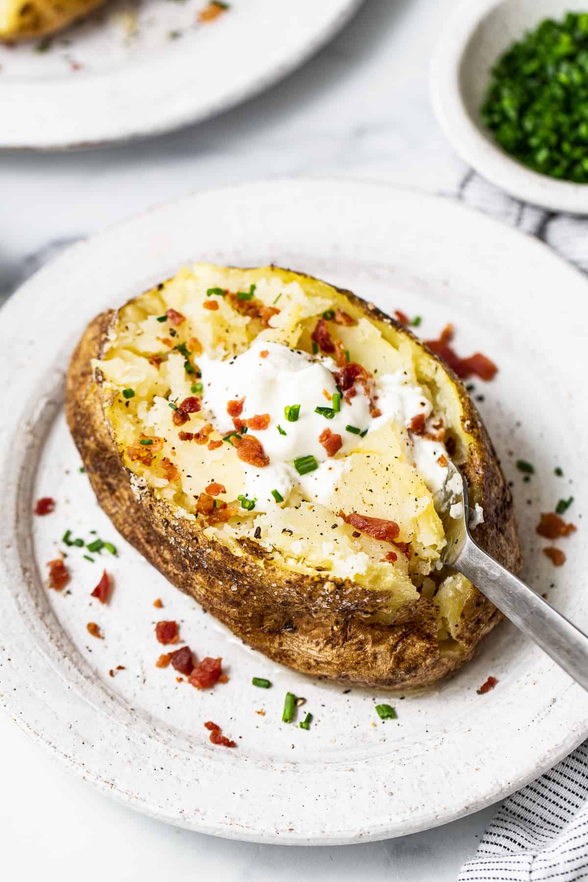 Microwave potato topped with toppings. 