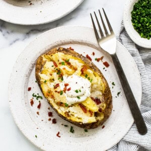 Baked potato topped with sour cream.