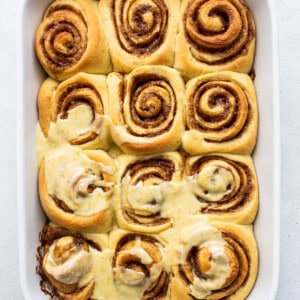 Frosting the orange rolls.