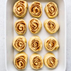 Sliced orange rolls in a casserole dish.