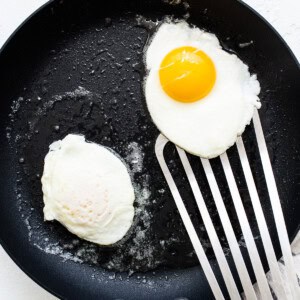 Two fried eggs in a frying pan.