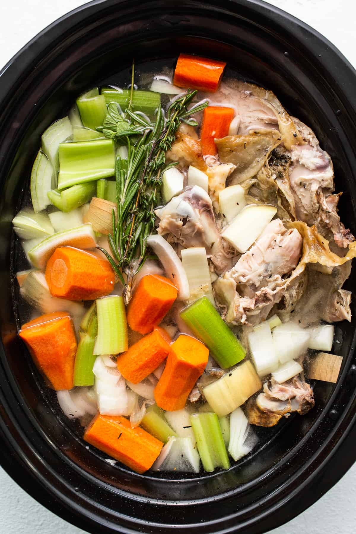 Turkey stock ingredients in a slow cooker. 