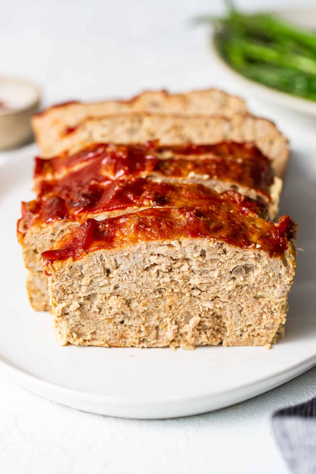 Ground turkey meatloaf sliced on a plate.