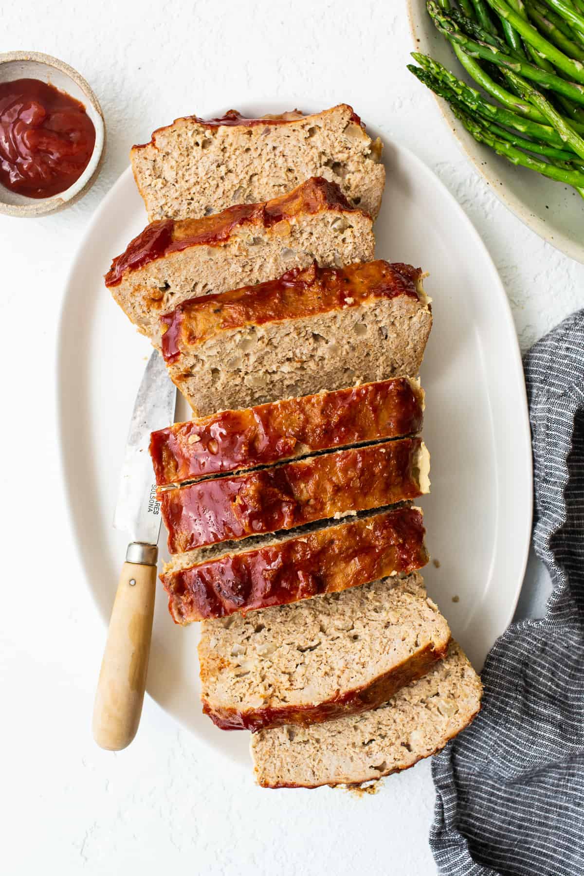 Ground turkey meatloaf sliced on a plate.