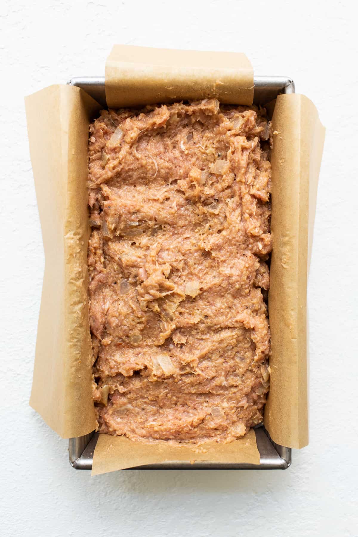 Ground turkey meatloaf in a loaf pan.