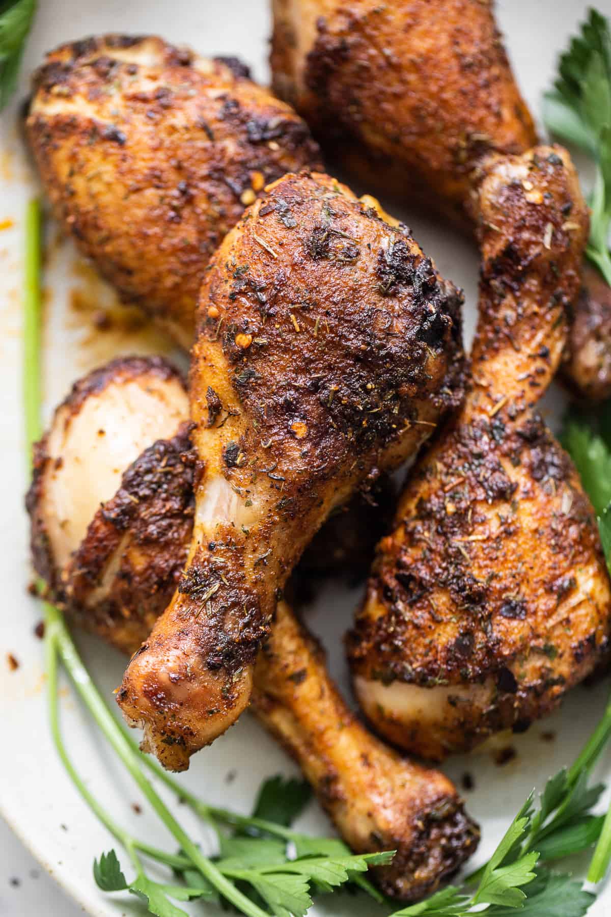 Baked chicken legs on a plate.