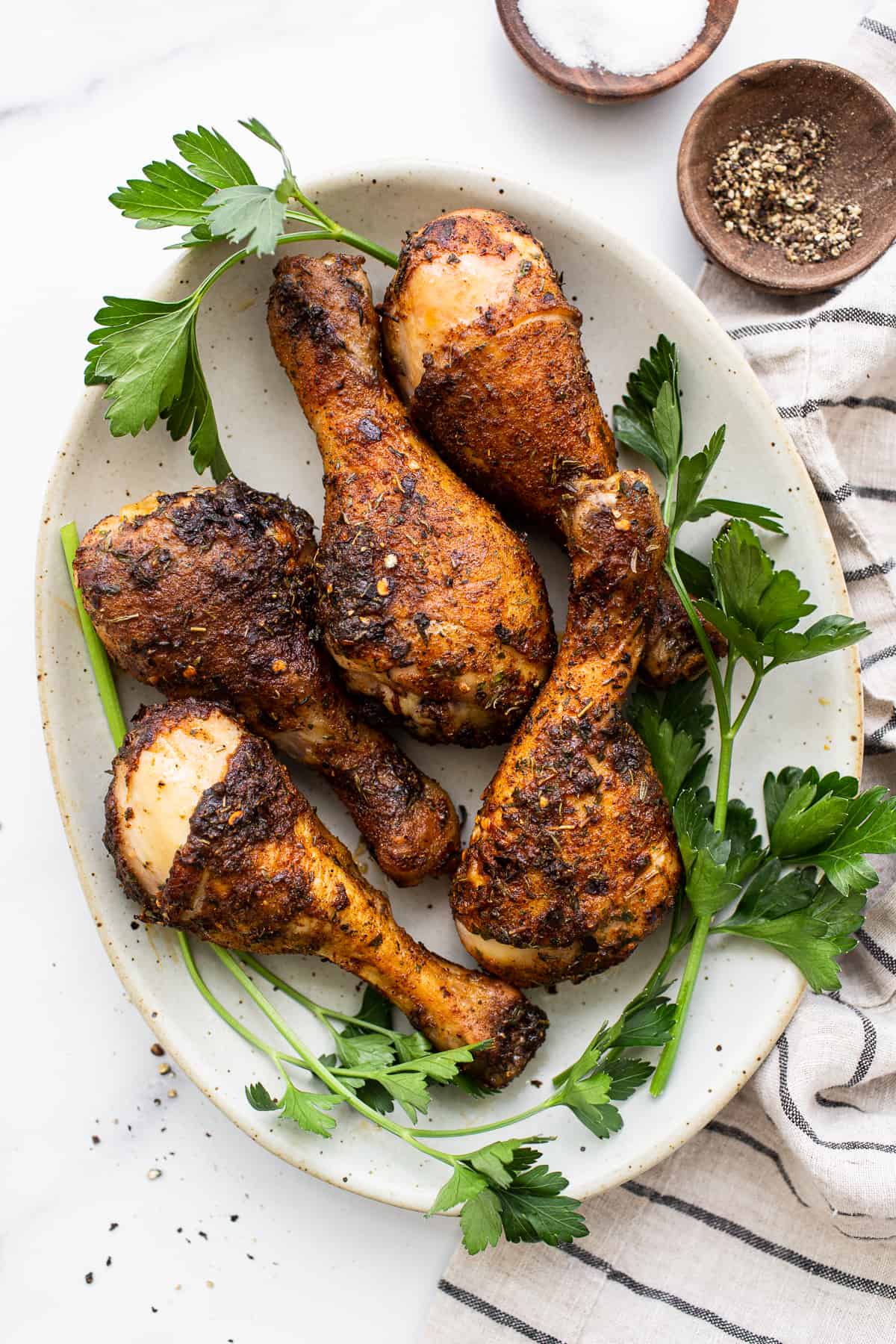 Baked chicken legs on a plate.