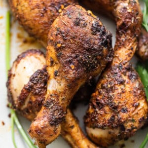 Baked chicken legs on a plate.