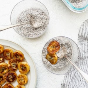 Chia seeds on a plate next to a bowl of chia seeds.