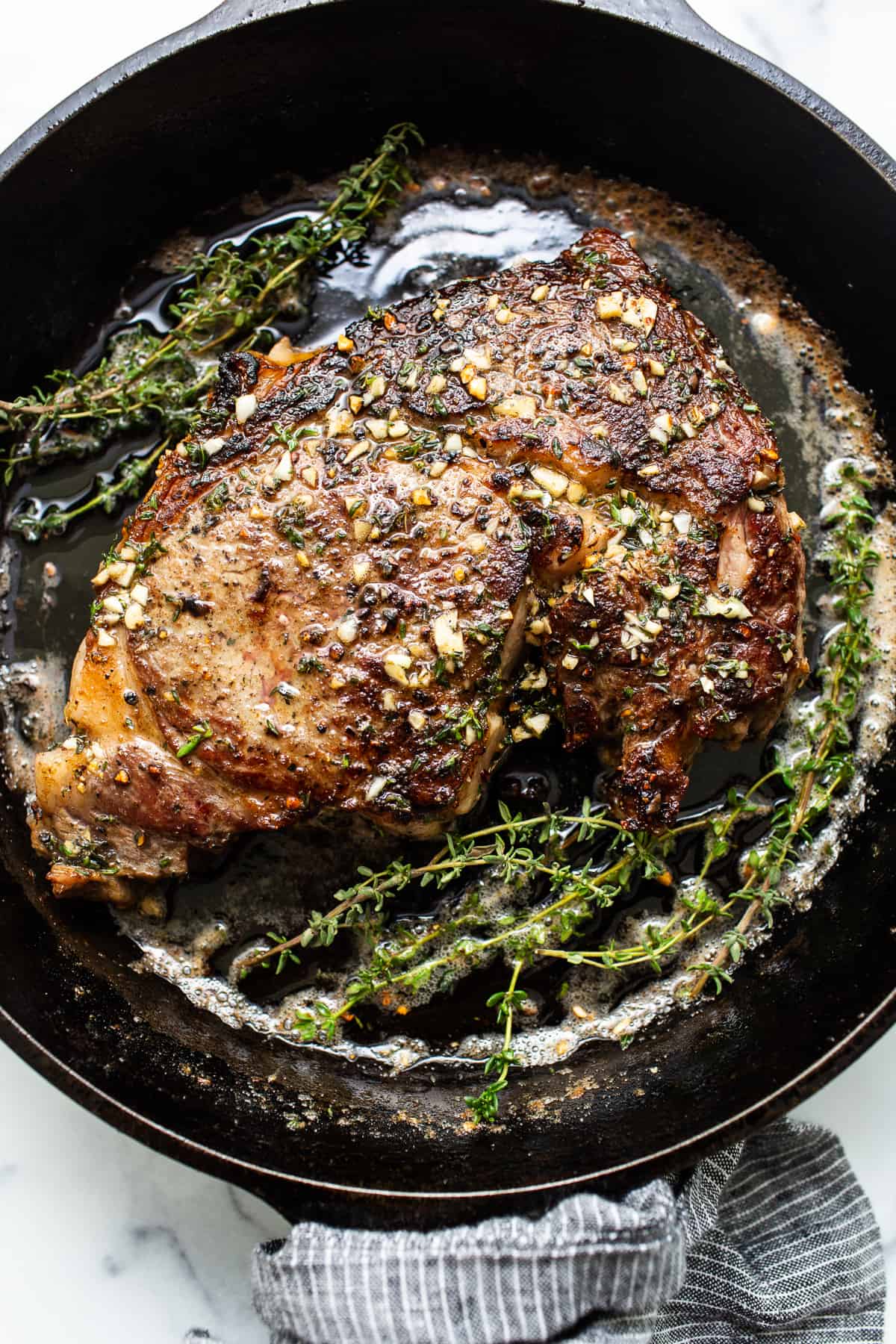 A cast iron steak in a pan. 