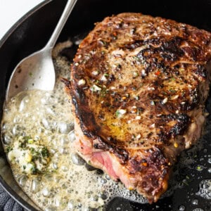 Searing a steak in a cast iron.