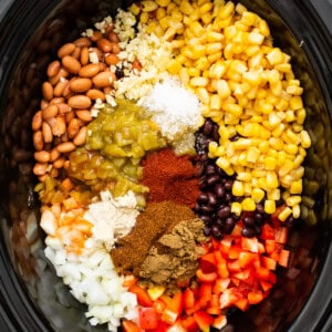 A crock pot full of ingredients for crock pot tacos.