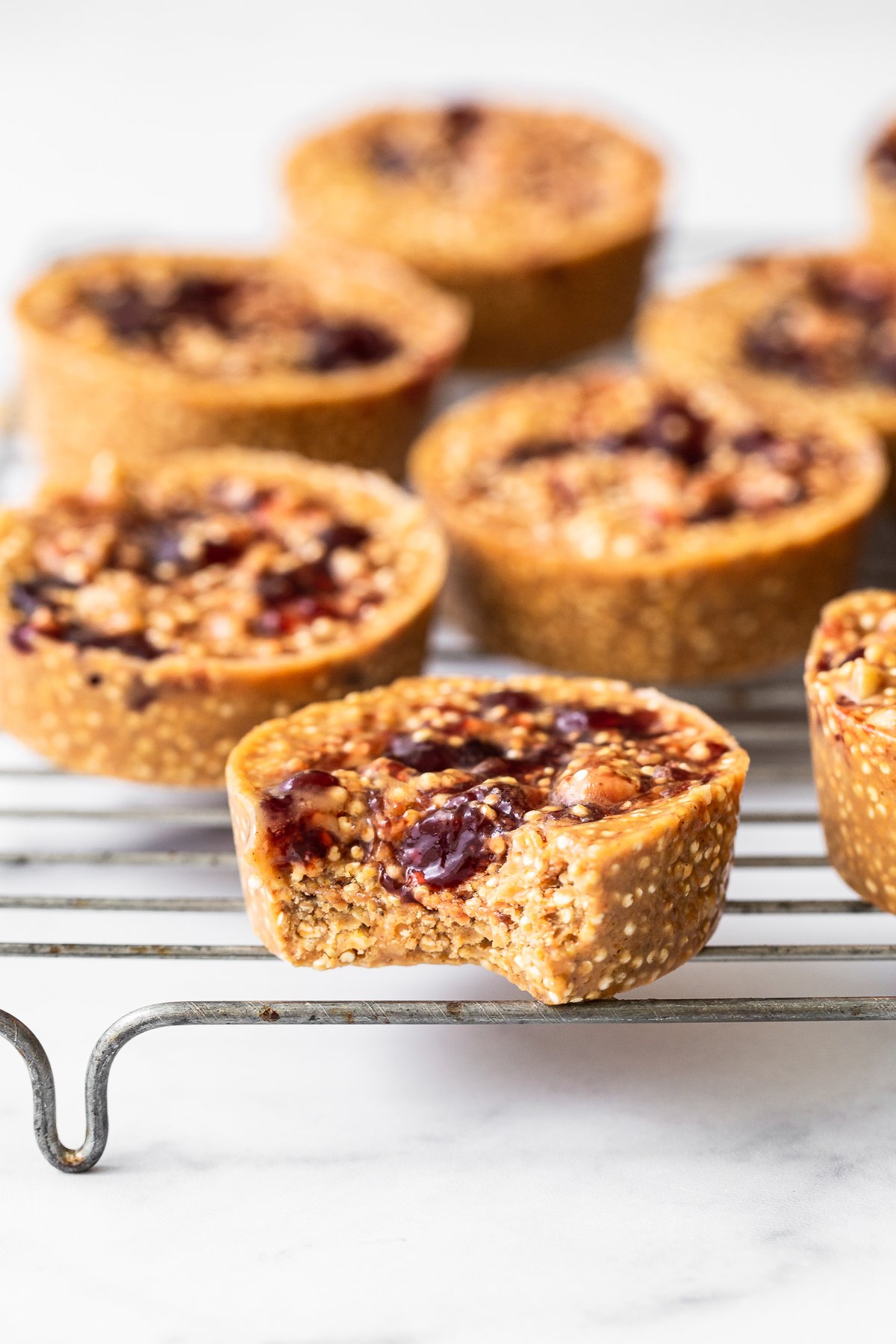 Peanut butter and jelly cups on a metal rack. 