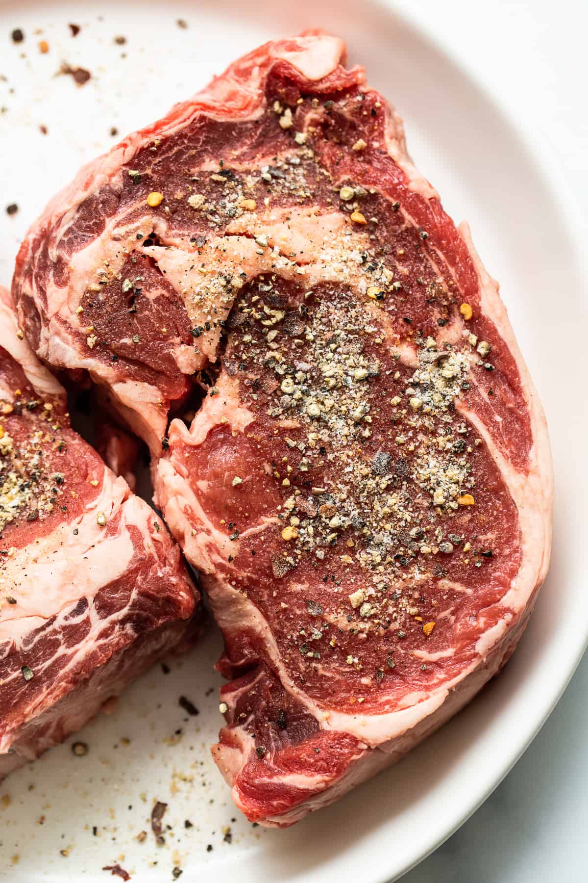 Steak seasoning on raw steak.