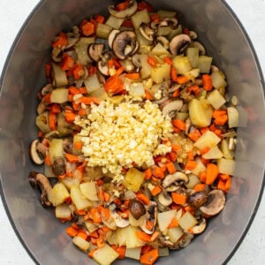 Vegetables and garlic in a Dutch oven.