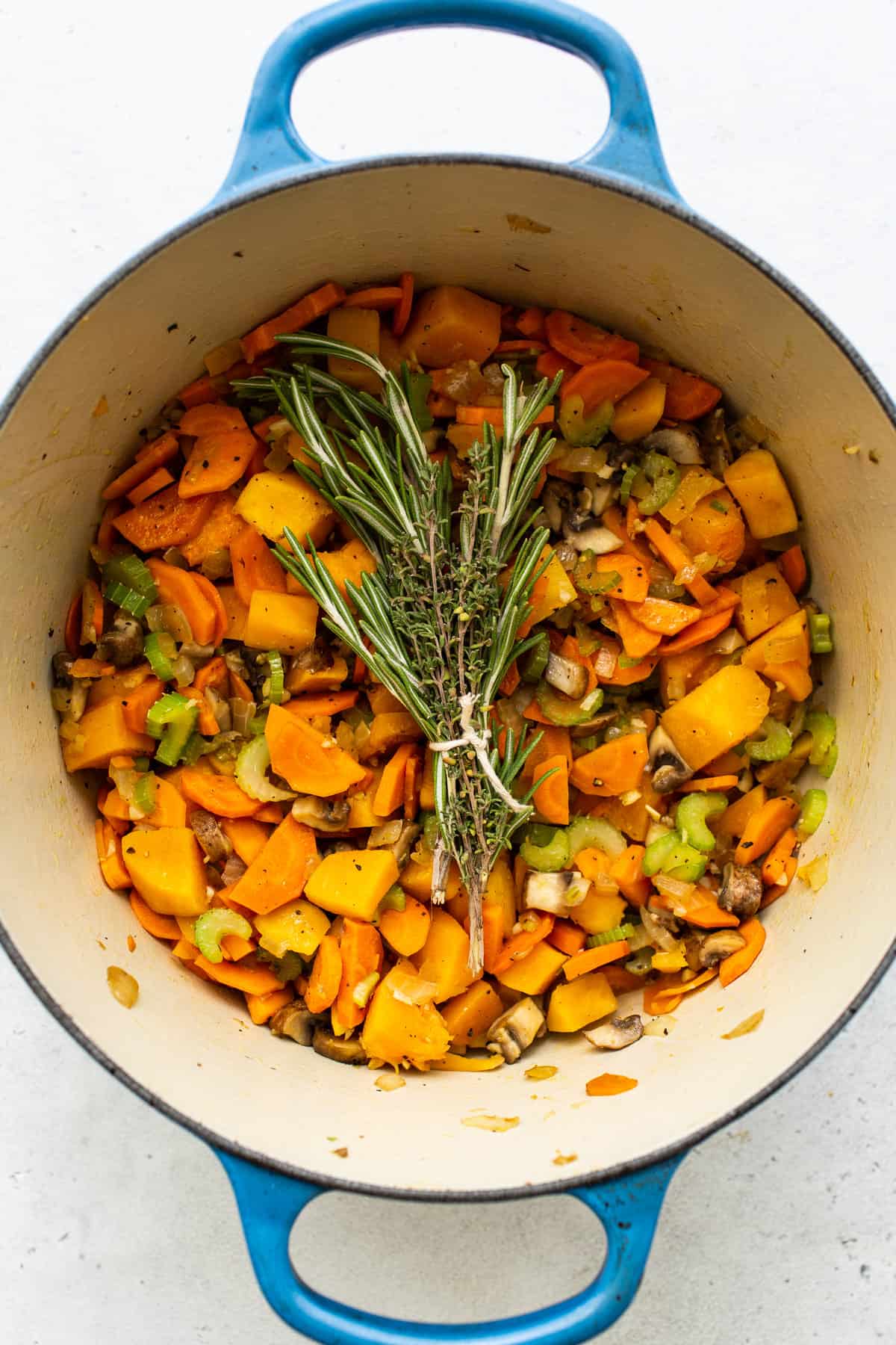 Veggies in a stock pot for turkey wild rice soup.