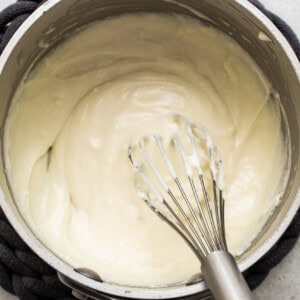 Whipping cream in a pan while preparing turkey wild rice soup.