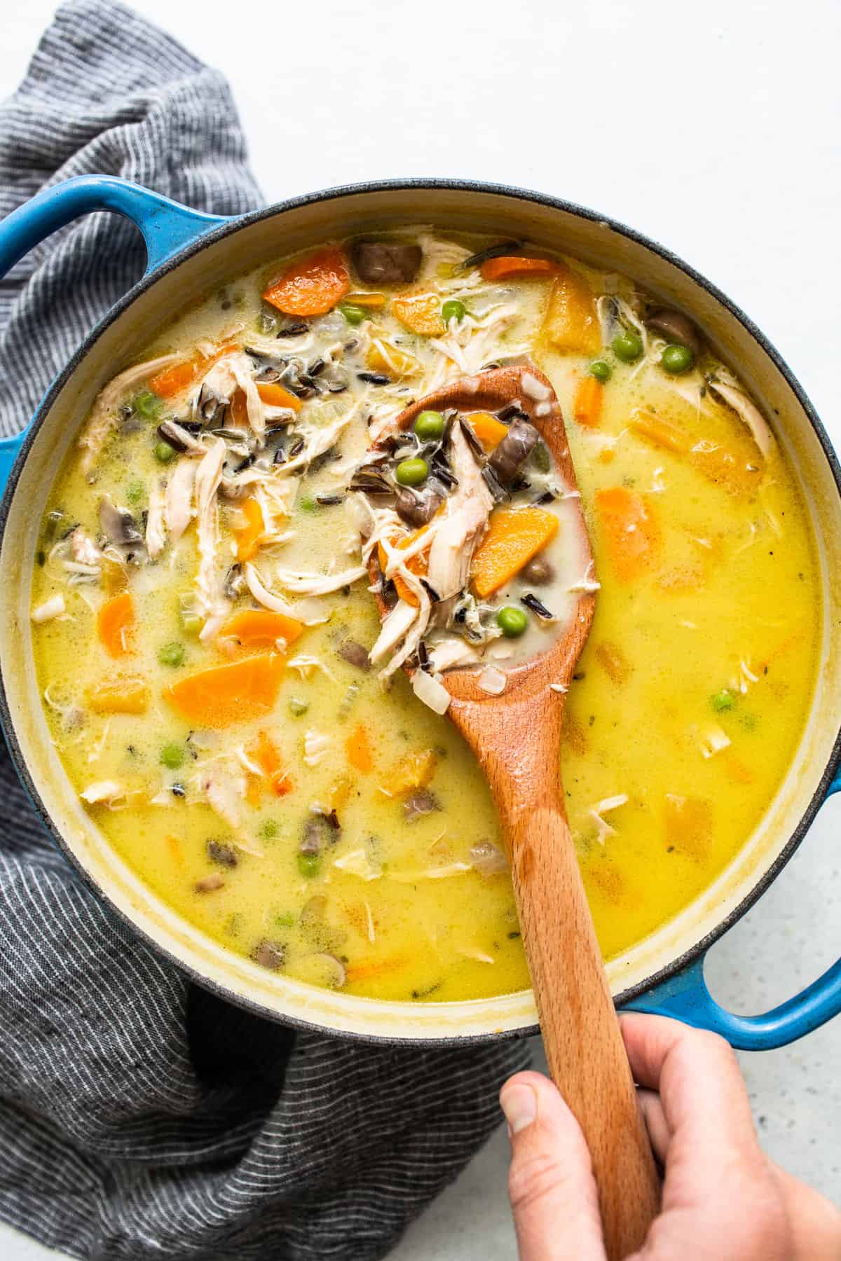 Turkey wild rice soup on a spoon.