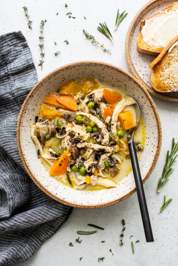 A bowl of turkey soup with vegetables.