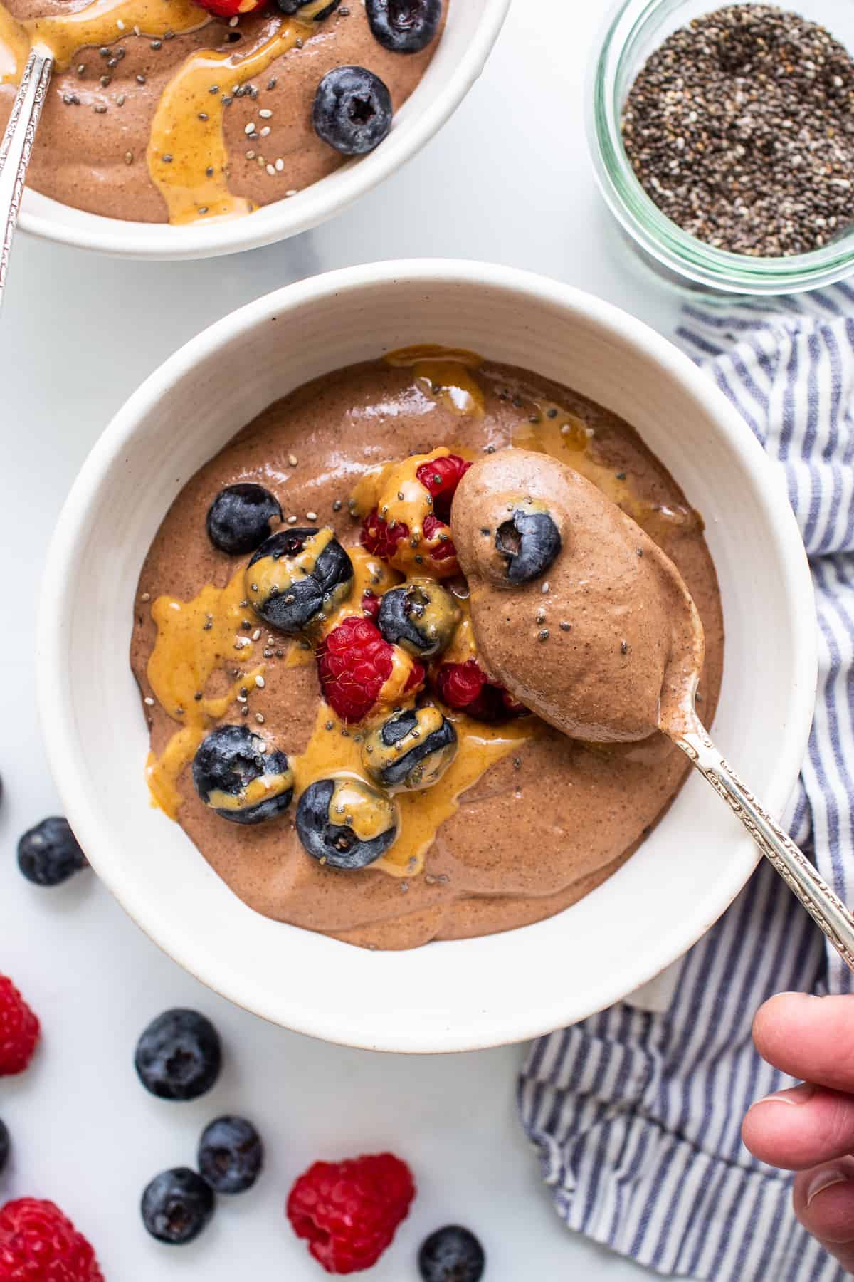 Blended chia seed pudding in a bowl with a spoon.