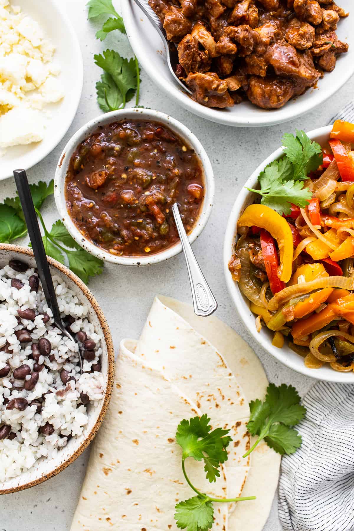 Ingredients for chicken fajita burritos on a counter.