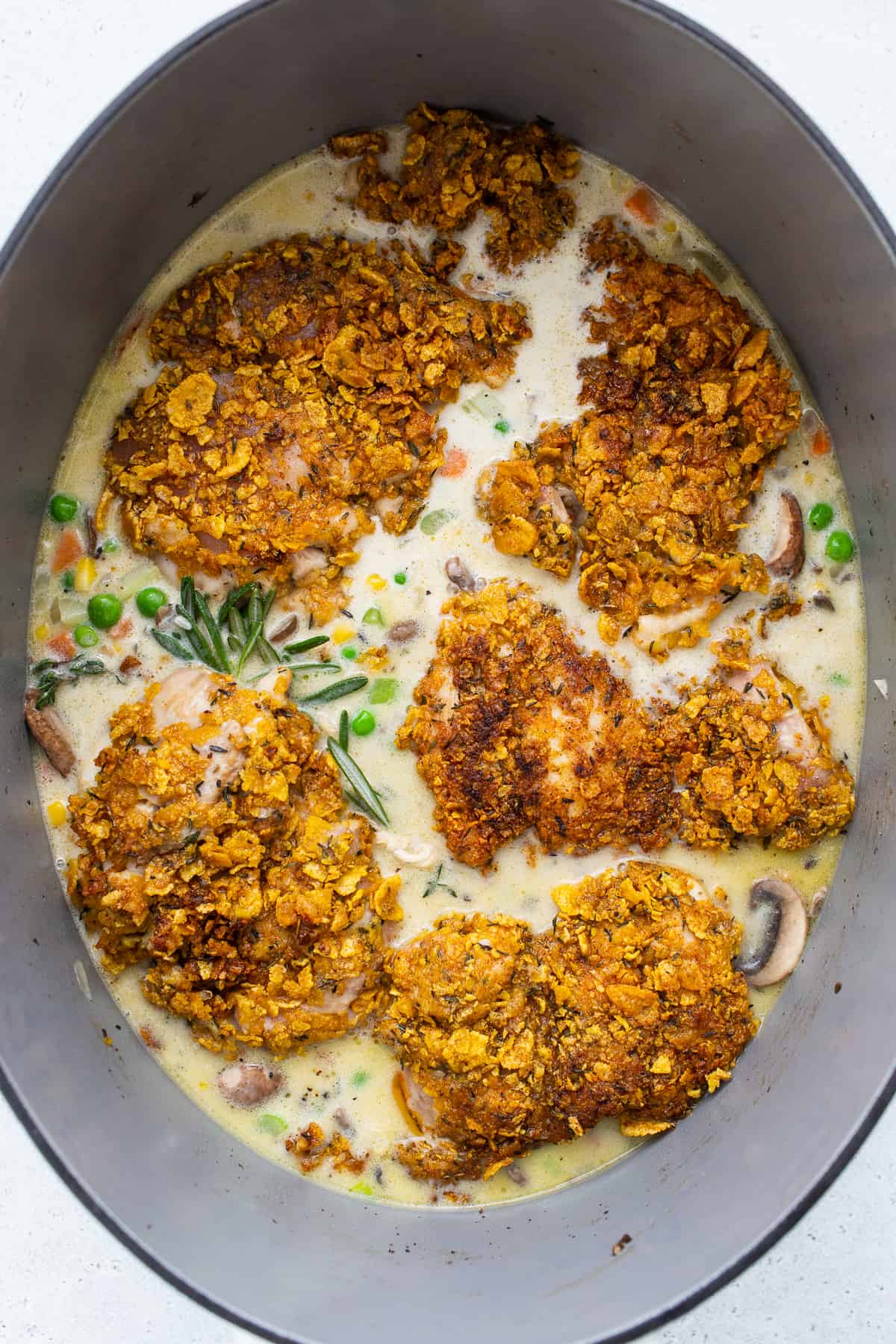 Chicken pot pie skillet in a skillet, ready to be baked.