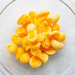 Broken eggs in a glass bowl.