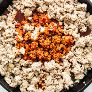 Ground chicken in a skillet.