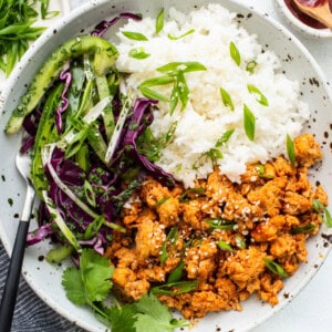 Ground chicken bowls with rice and coleslaw.