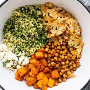 All of the ingredients for the couscous salad in a bowl.