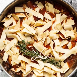 A skillet filled with meat and noodles.