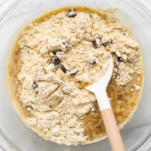 A bowl of ingredients with a wooden spoon in it.