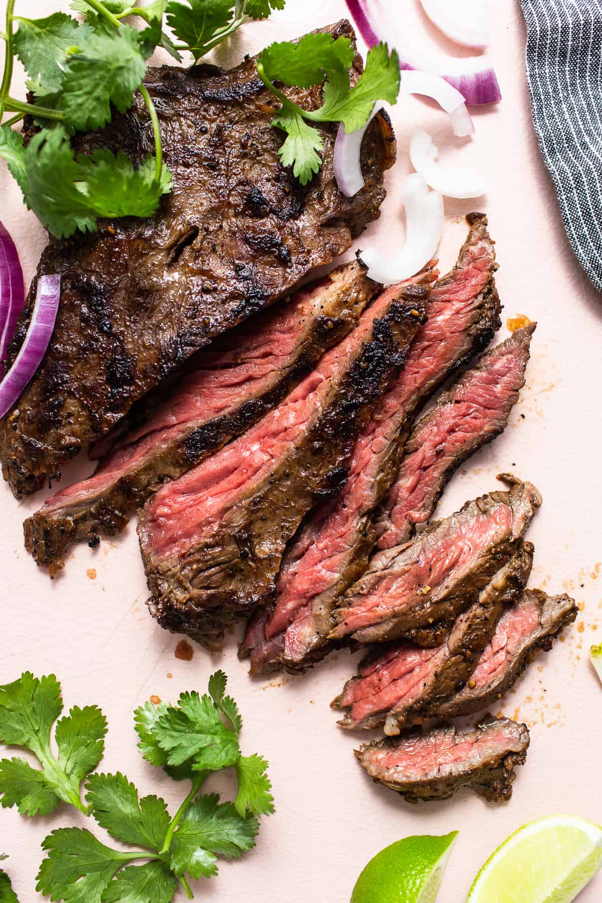 Sliced skirt steak on a cutting board.