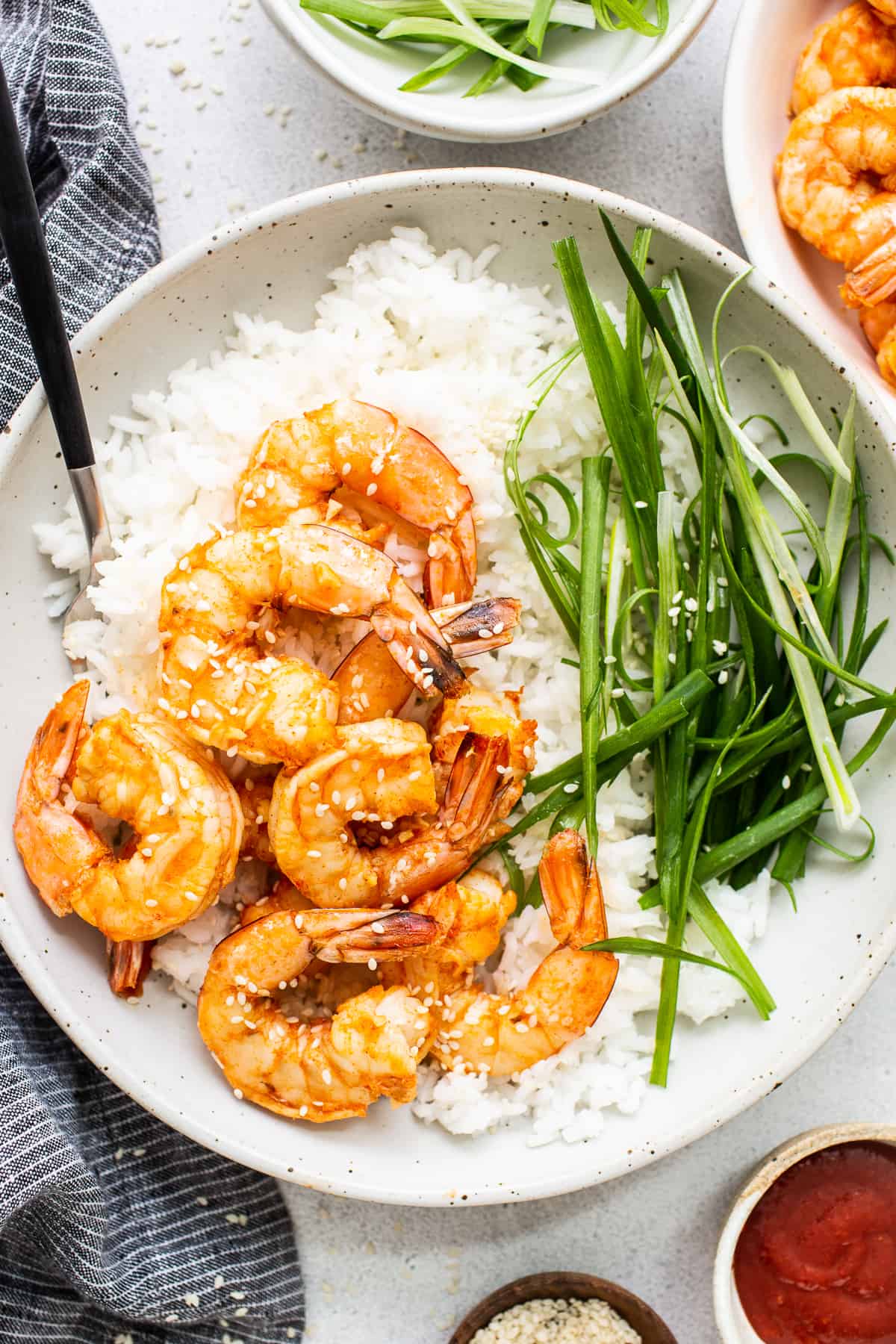 Spicy garlic prawns in a bowl with rice.