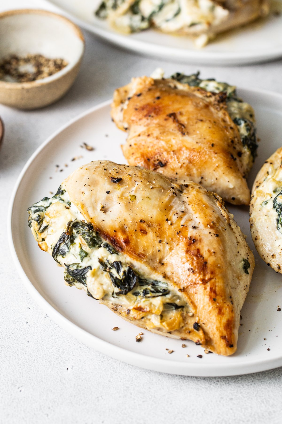 Spinach stuffed chicken breast on a plate.