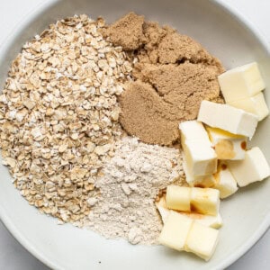 Oats, butter, sugar and cinnamon in a bowl.