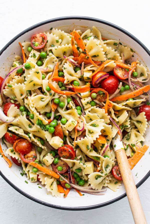 Bow tie pasta salad in a bowl.