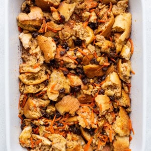 A white baking dish filled with bread and carrots.