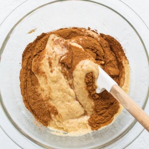 Adding cinnamon to the cake batter.