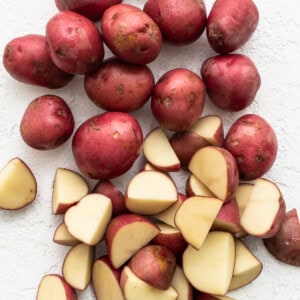 Sliced red potatoes on a white background.