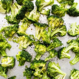 Roasted broccoli on a baking sheet.