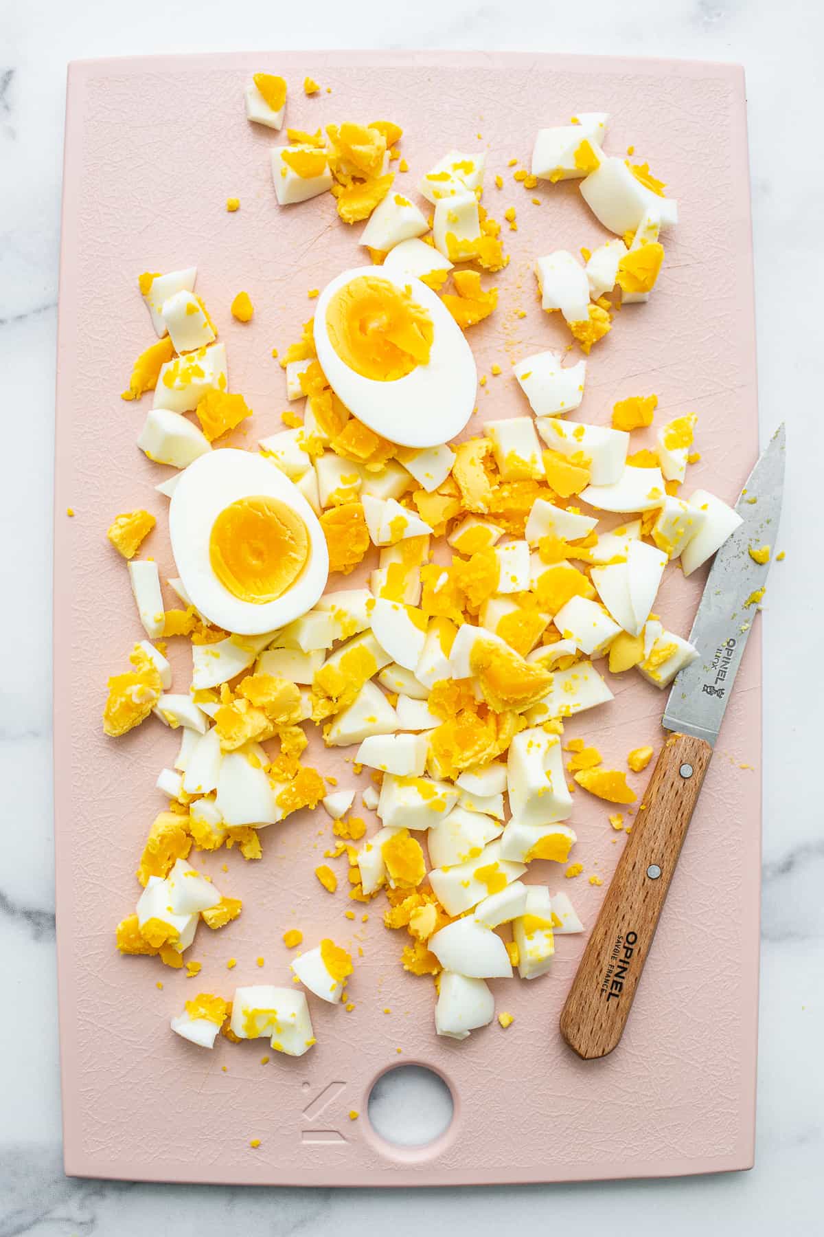 chopped eggs on cutting board.