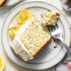 Slice of lemon poppy seed cake on a plate.