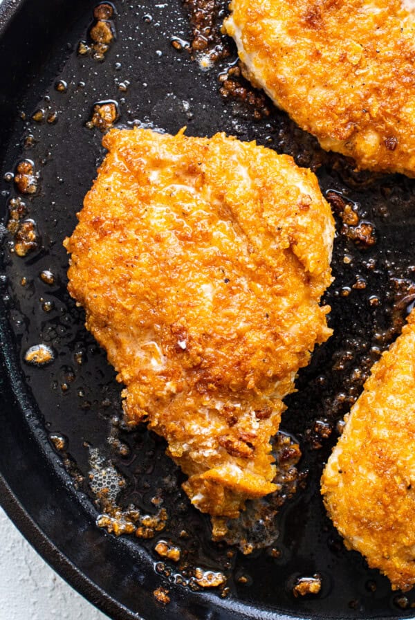 cooking chicken in pan.