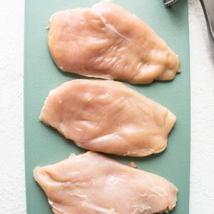 chicken breast on cutting board.