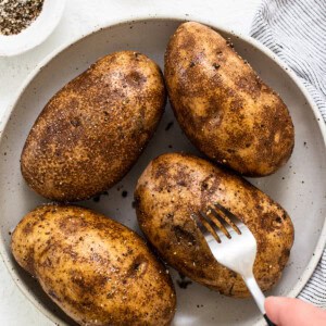 poking holes in potatoes.